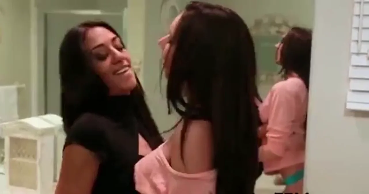 Lyla Storm and Tiffany Tyler kissing in the bathroom.