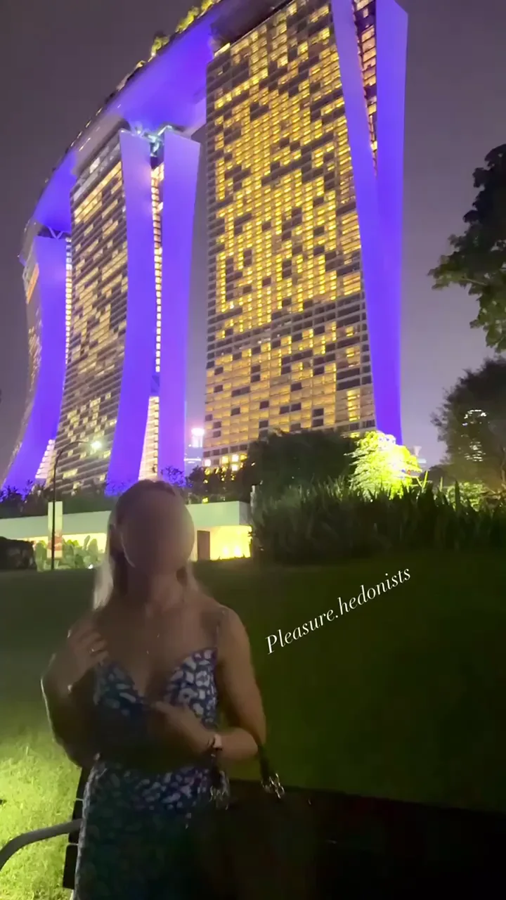 Petite Blonde's Naughty Titty Drop in Front of Marina Bay Glow