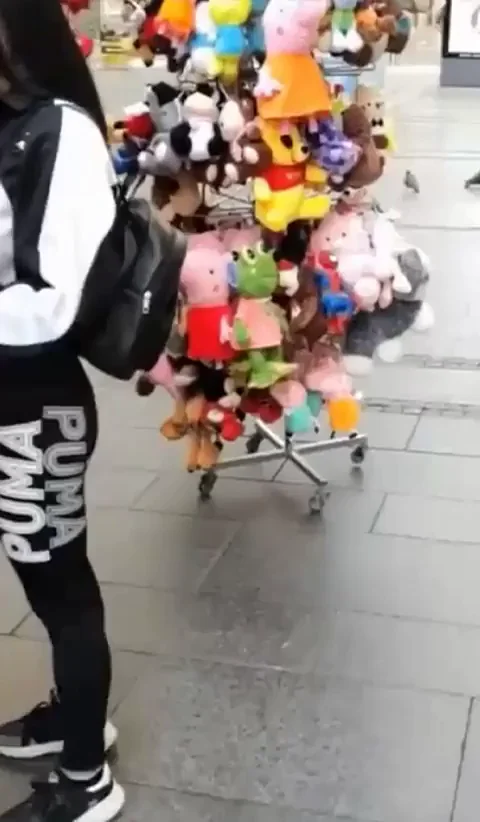 Slutty Babe Tries On Football Shirt Topless in Public Market
