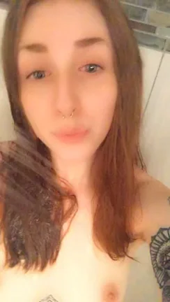 Bathroom Tease: Tattooed Slut Shares Her Perky Tits & Sly Smile