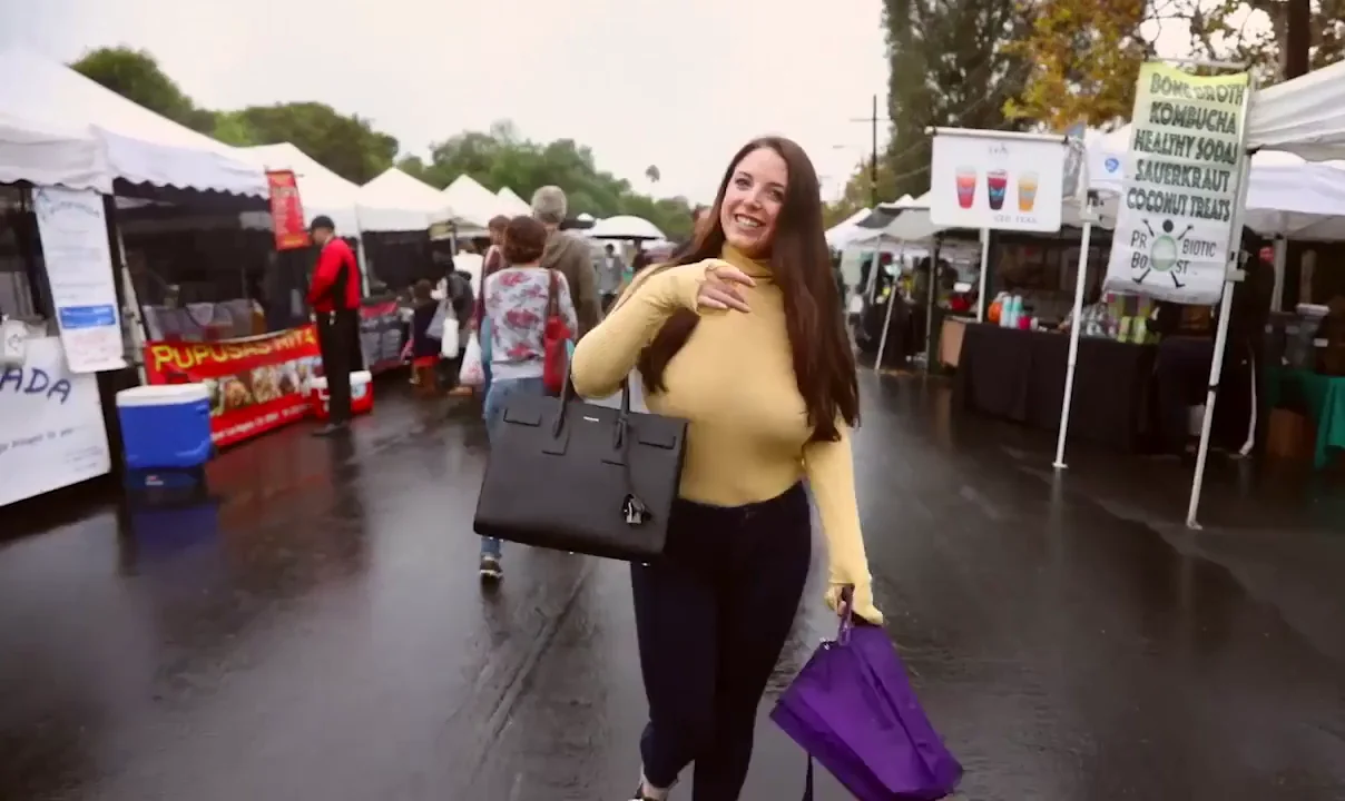 Angela White Teases with Massive Tits Shake in Public Marketplace