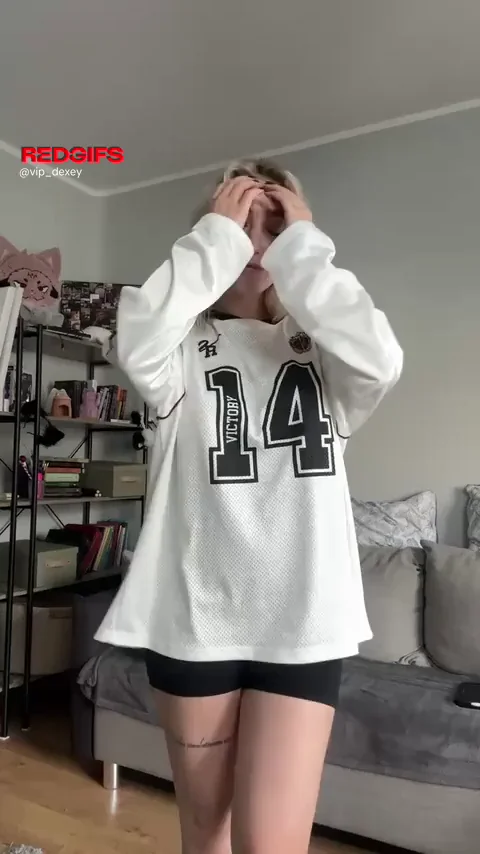 Teasing Amateur Slut Strips Out of Oversized Jersey, Flashing Perky Big Tits
