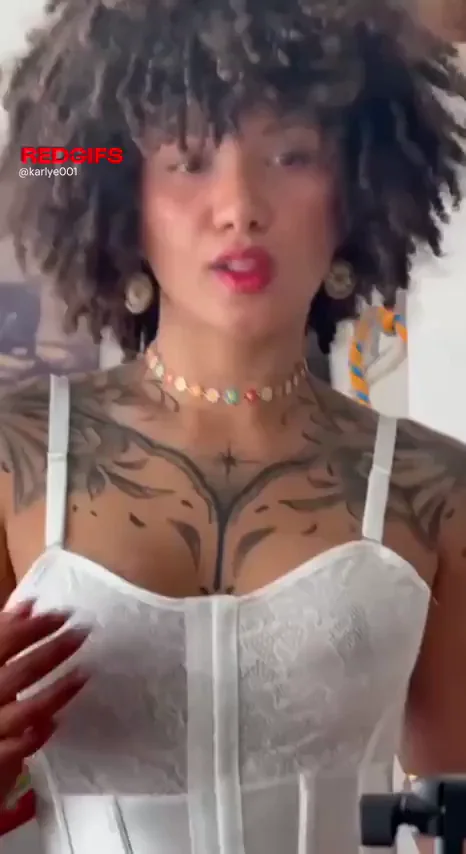 a ebony woman in white lingerie looks powerful