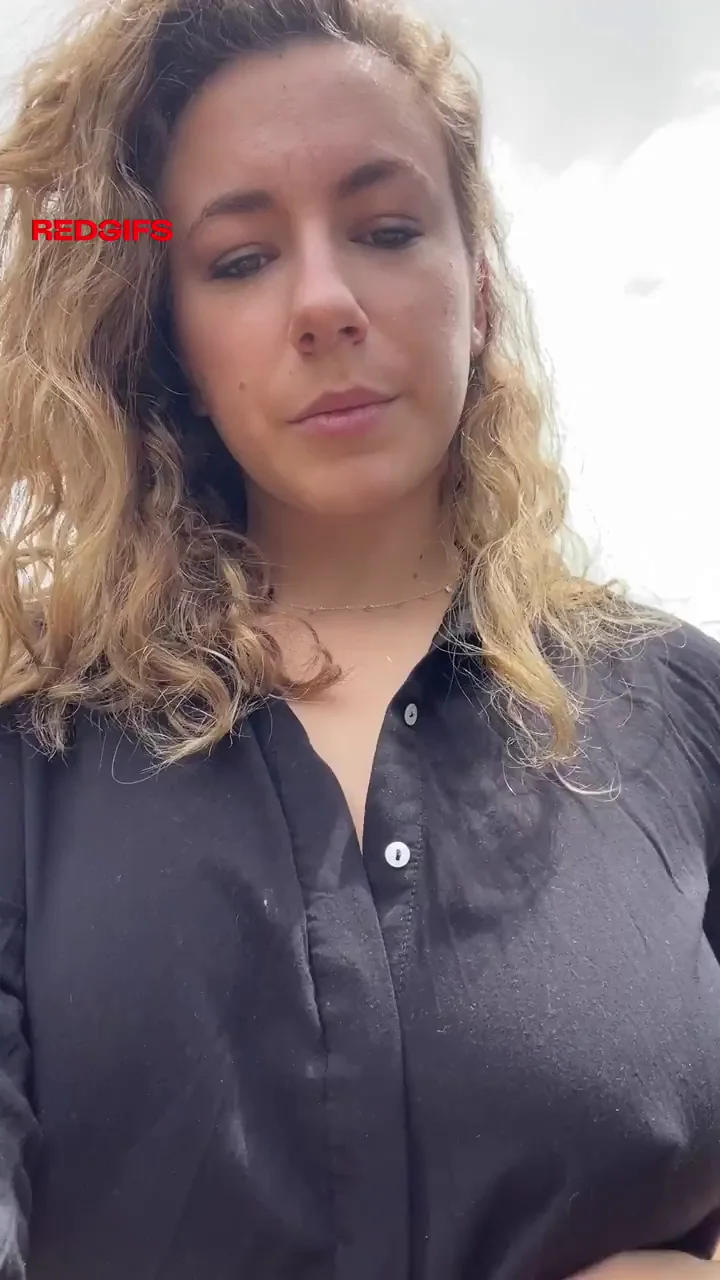 Bra-Free Bombshell: Pokies Poppin' in Shiny Black Top!