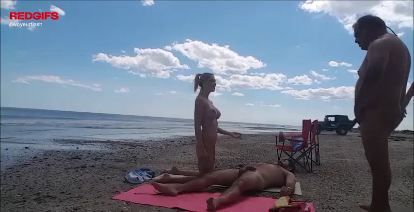 Wife plays with strangers on the beach