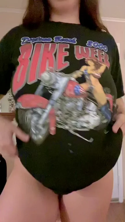 Thick Babe Teases in Vintage Dyke Week Shirt, Lifting to Flash Massive Tits