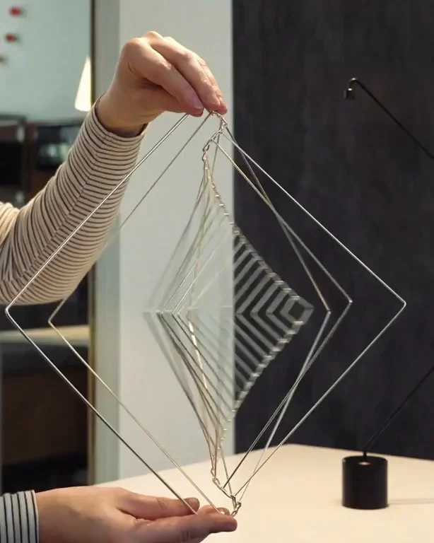 Girl fidgeting with a kinetic sculpture