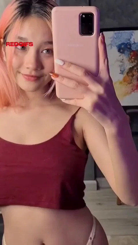 Pink-Haired Asian Bombshell Teases Her Massive Natural Tits Reveal