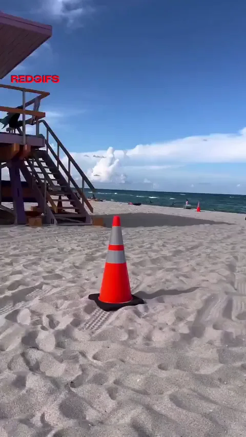 Beach Cone Tease: Bikini Bombshell Owns the Shore