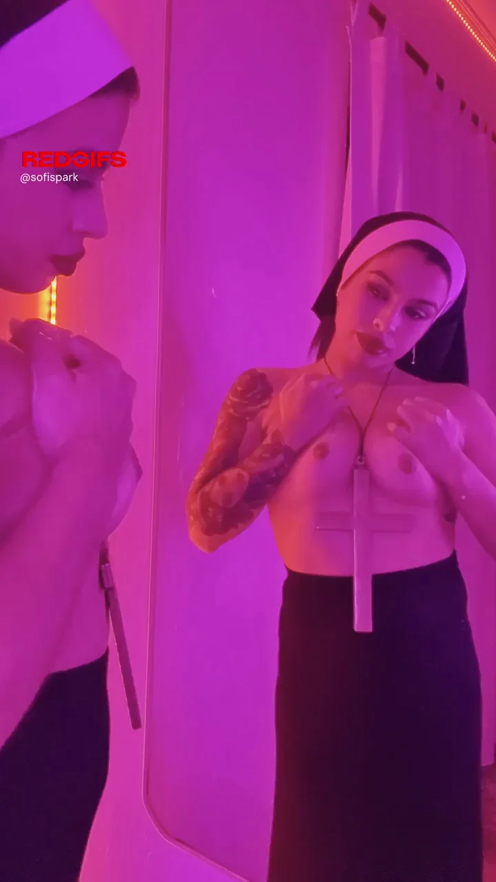 Naughty Nun Teases Tits in Pink Glow Mirror Show