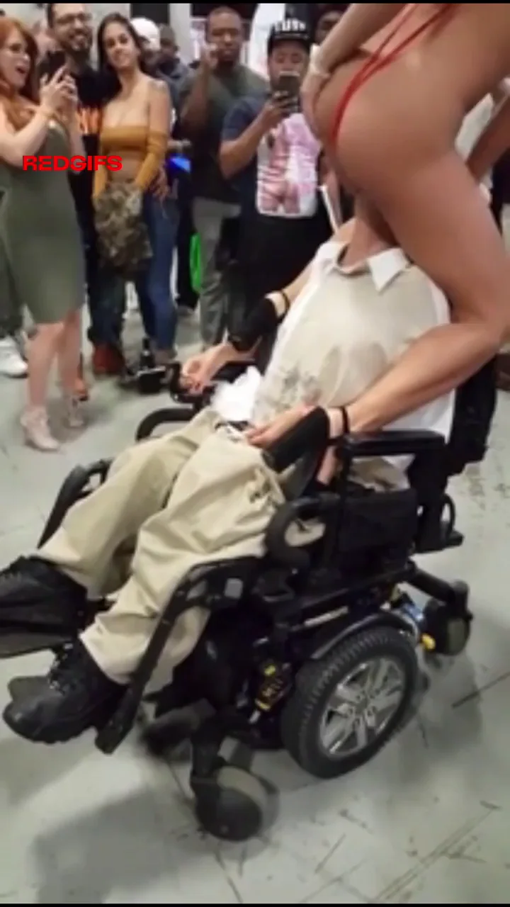 Adriana Chechik facesitting a fan in wheel chair
