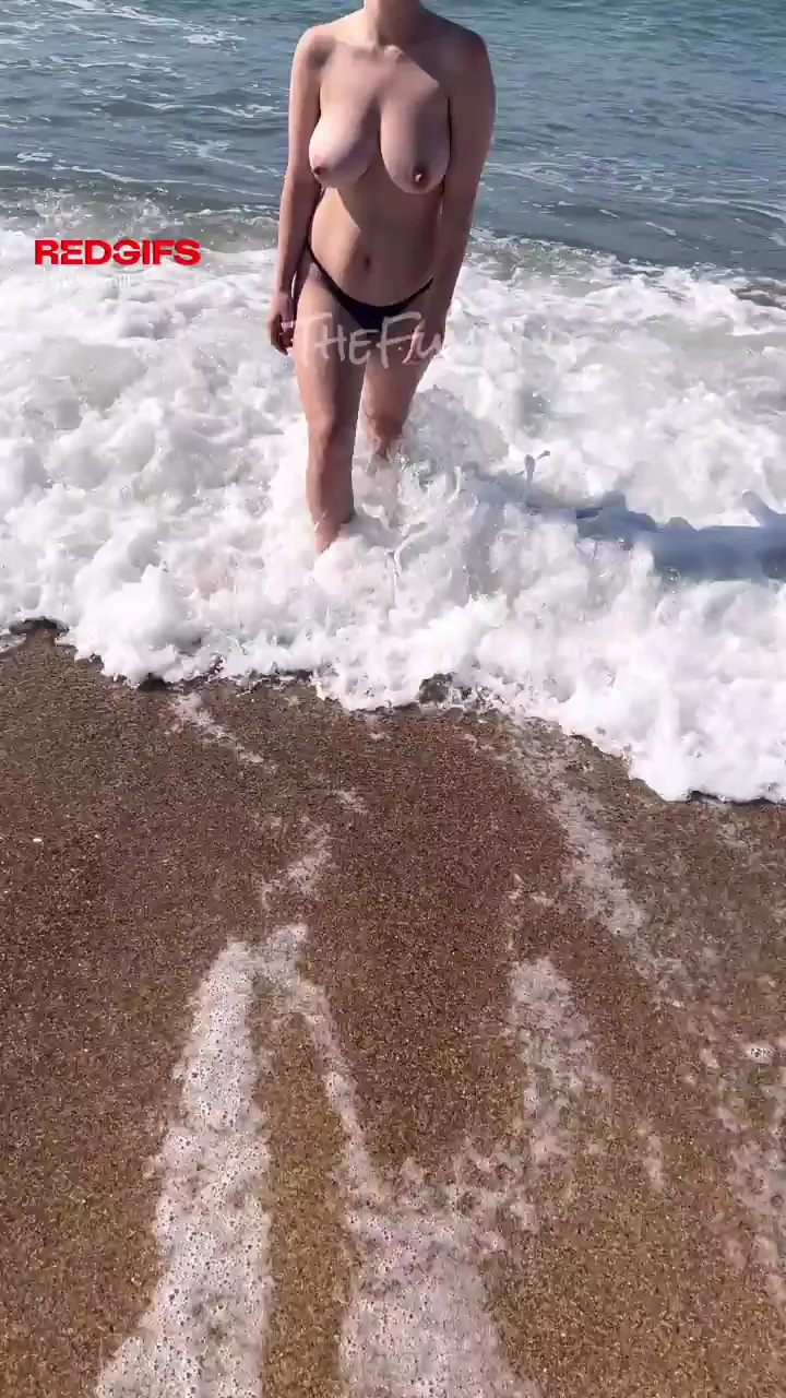 Beach Slut Flashes Massive Nipples in Public Waves
