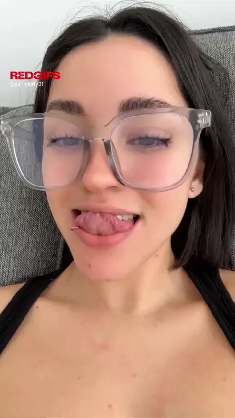 Tongue Out Tease from Glasses-Wearing Teen Slut's Juicy Tits