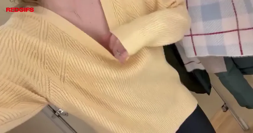 Trying on a new top for work.
