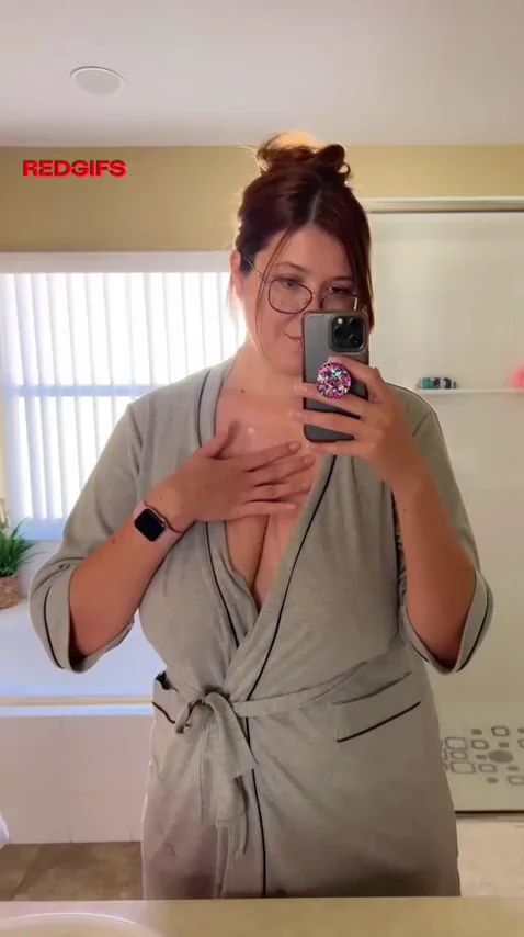 Robed Redhead's Big-Tit Tease in the Bathroom Mirror