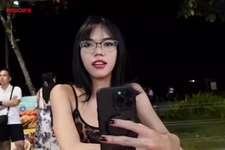 Asian Ladyboy Teases with Sultry Phone Selfies in Public Park