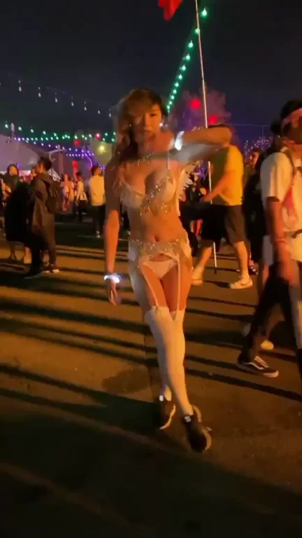 Festival Slut's Thigh-High Tease Under Neon Lights