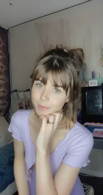 Petite Tease Promises Full Reveal in Purple Mini Skirt