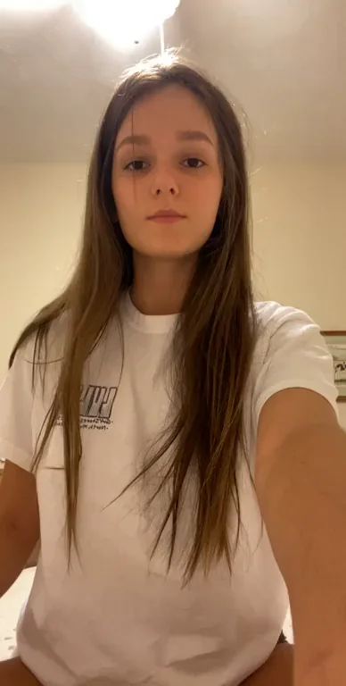 Teasing Eyes: Slim Cutie Lifts Tee for Bedroom Flash