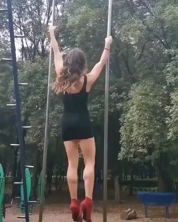 Tight Dress Slut Hangs Upside Down on Playground Poles