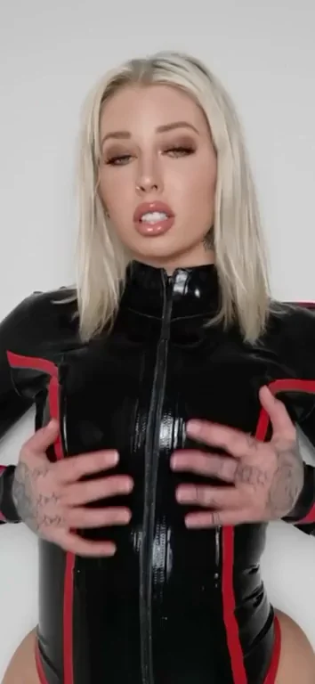 Who's This Busty Blonde in Shiny Red-Trimmed Latex? 🍑🔥