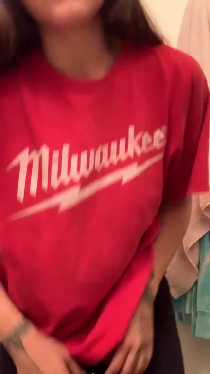 Sneaky Bathroom Tease: Petite Slut Lifts Milwaukee Tee to Flash Tatt'd Tits 🍆💦
