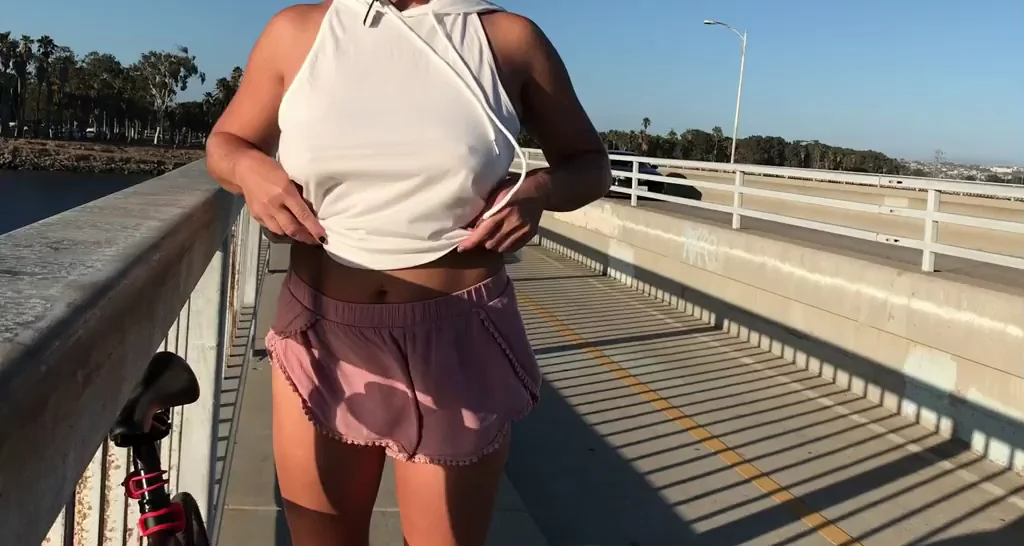 Getting risky and showing off my boobies in front of a bunch of passing cars.