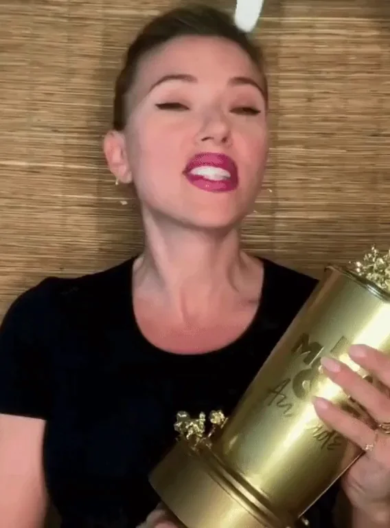Scarlett Johansson Sucking on a Massive Gold Cock-Shaped Trophy