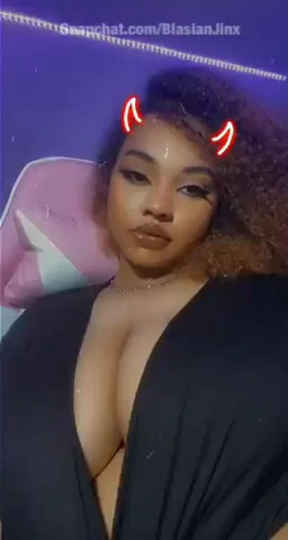 Thick Ebony Babe with Devil Horns Teasing Massive Cleavage