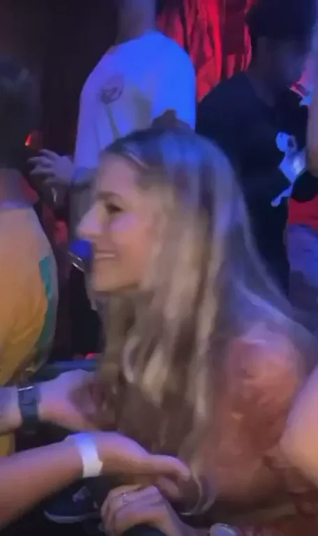 Random guy bouncing her tits at the club