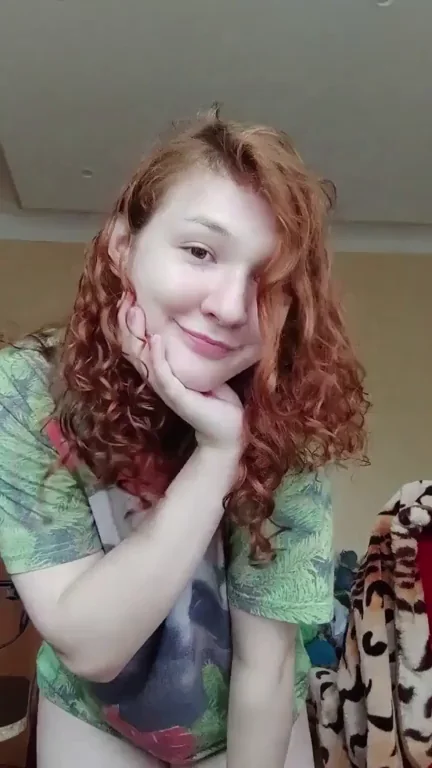 Redhead Cutie Flashes Tits and Shaved Pussy with Naughty Smile