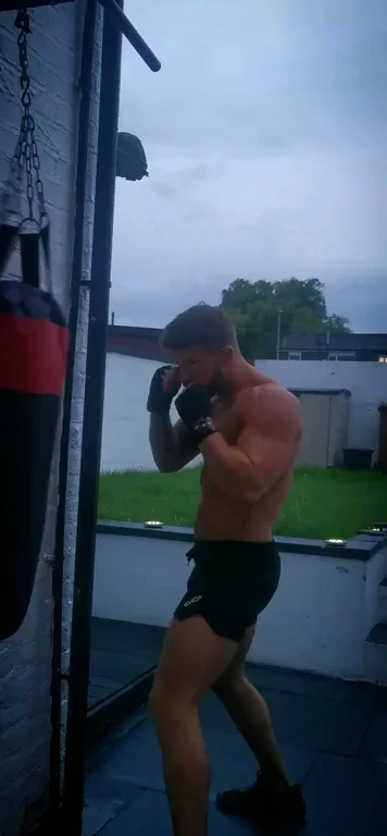 💪 Topless Hunk Smashes Punching Bag in Tiny Shorts! Drop 'Em? 🔥🍑