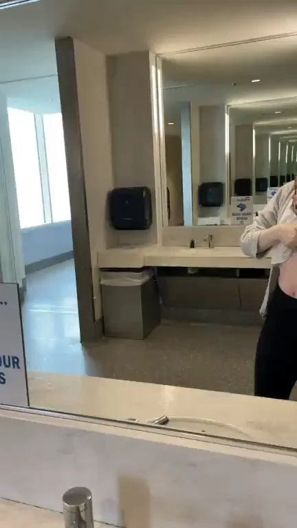 Risky Airport Bathroom Tits Flash GIF