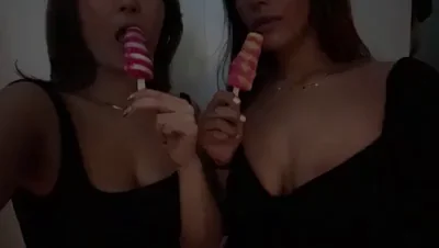 Korean girl sucking popsicles with her Malaysian roommmate