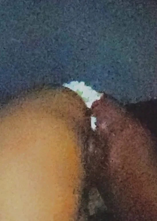 Ebony couple playing with cake
