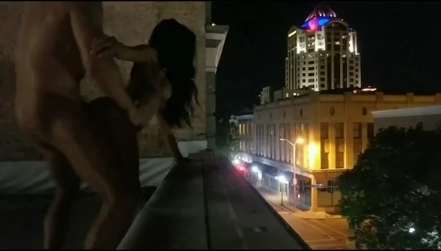 Rooftop Public Pounding with City Lights Below