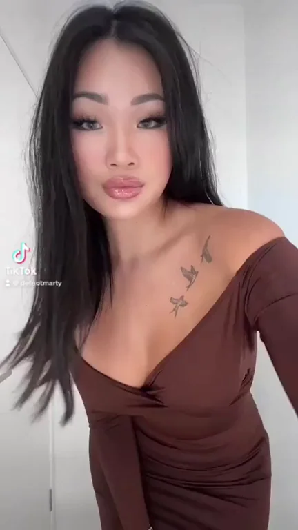 Asian Bombshell's Tight Dress Tease: Slutty Curves on Full Display