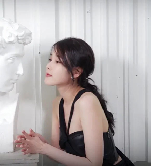 IU's Sultry Black Leather Tease with Marble Dick Bust