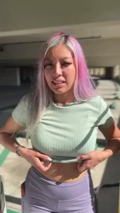Pink-Haired Latina Slut Flashes Perky Naturals Under Sports Bra in Public Garage