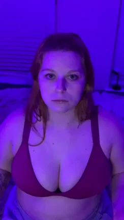 Redhead Bombshell Ball-Gagged & Busting Out in Purple Glow Tease