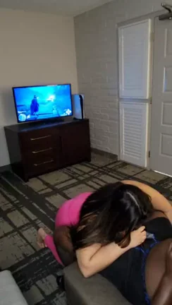 Sucking his wand while he plays Hogwarts Legacy.