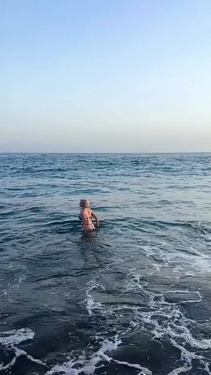Very beautiful and happy woman in bikini at the beach