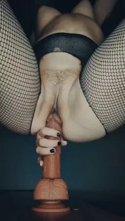 Enjoying one of her many dildos.