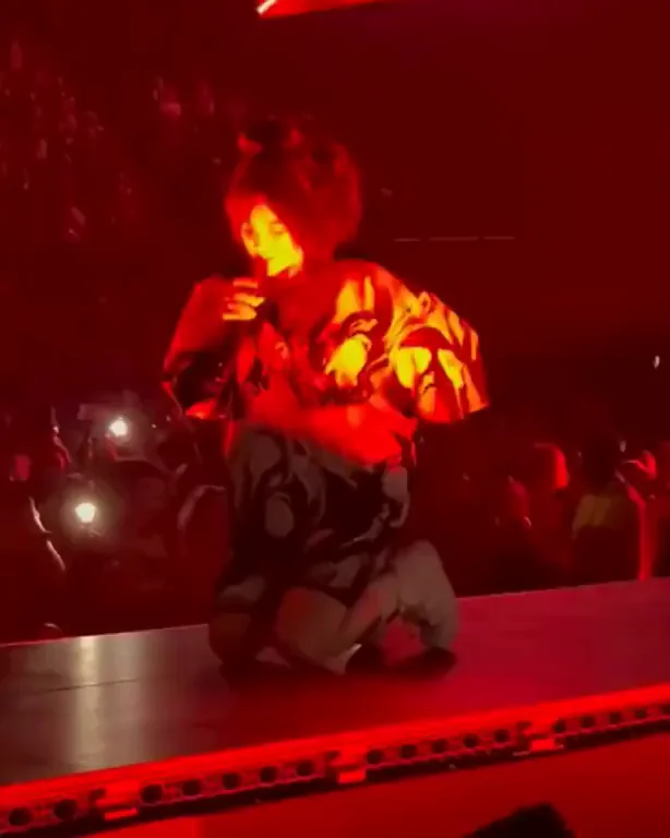 Billie Eilish Dropping to Her Knees in Sultry Red Glow