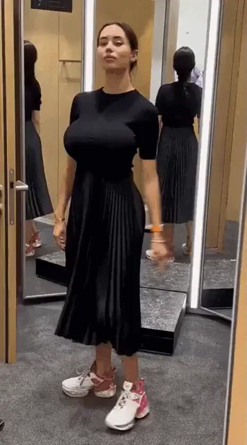 🍑 Busty Babe's Sleek Black Dress Tease in Fitting Room 🔥