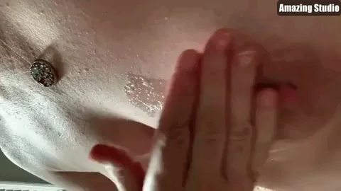 Applying cum from her hand to her nipples