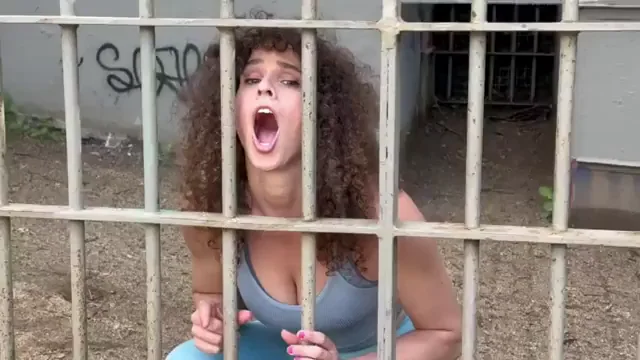 Curly Haired MILF Slave Begs for Cock Behind Bars Outdoors