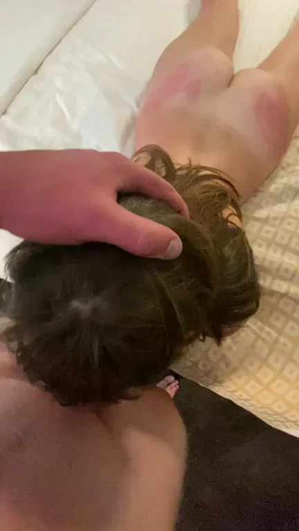 Adding another mark to her ass as she throats my cock while blindfolded