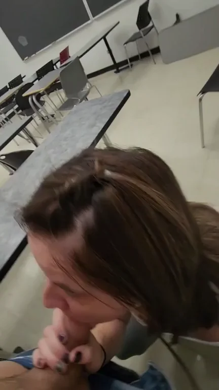 Sucking a students cock in a classroom while people walk around outside
