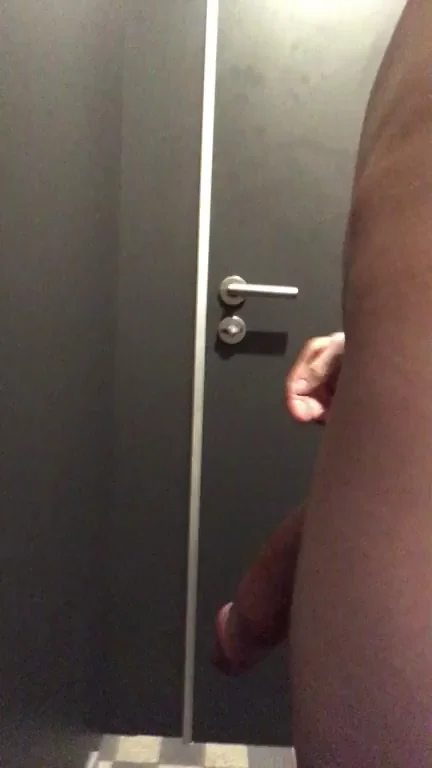 Opening the door of a public bathroom while fully naked